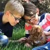 Boys with brown Cockapoo puppy